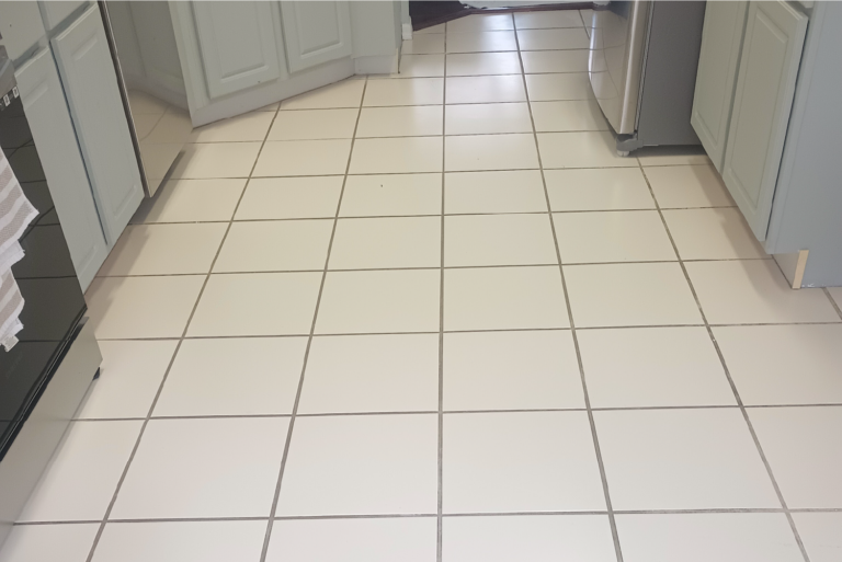 Kitchen tile floor with discolored grout before professional cleaning in Port Charlotte Florida